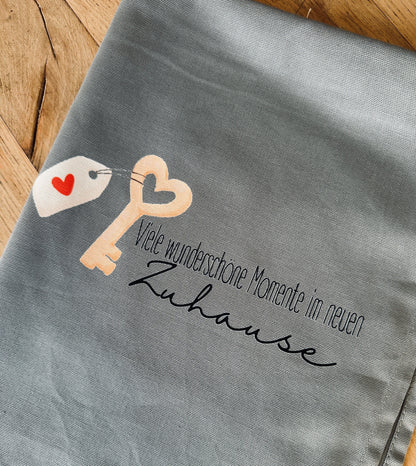 Geschirrtuch „Viele wunderschöne Momente im neuen Zuhause“ – stilvolles Einzugsgeschenk aus Baumwolle